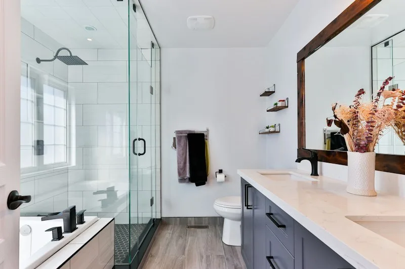 Refinished tub and tiled shower enclosure with a glass door in an Irvine home